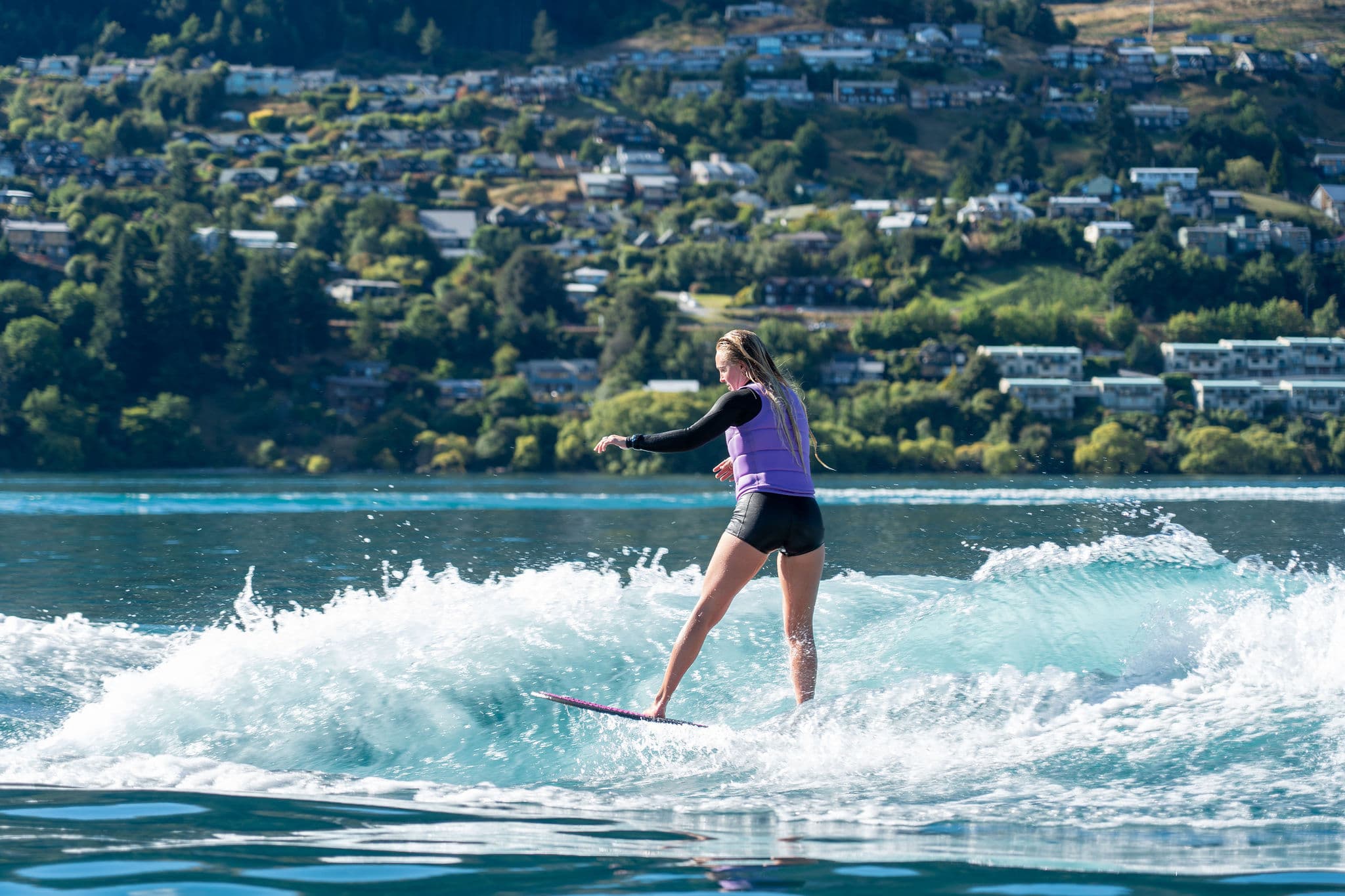 Coach Emma Galusha surfing the wave with the rope gone